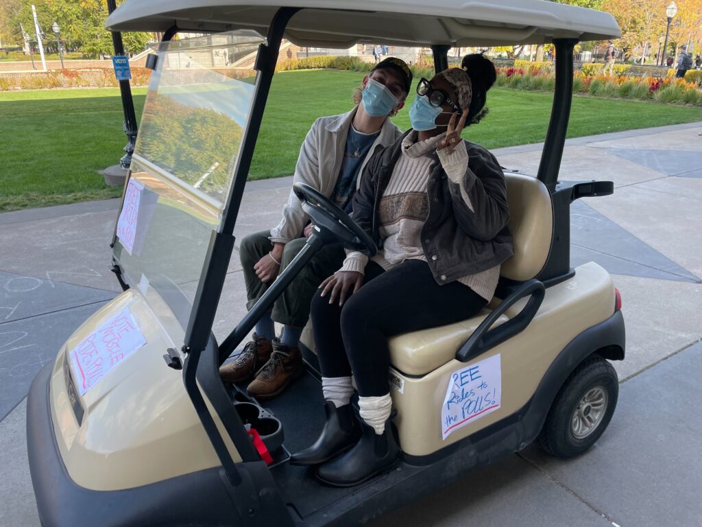 MNYC staff driving students to polls in golf cart